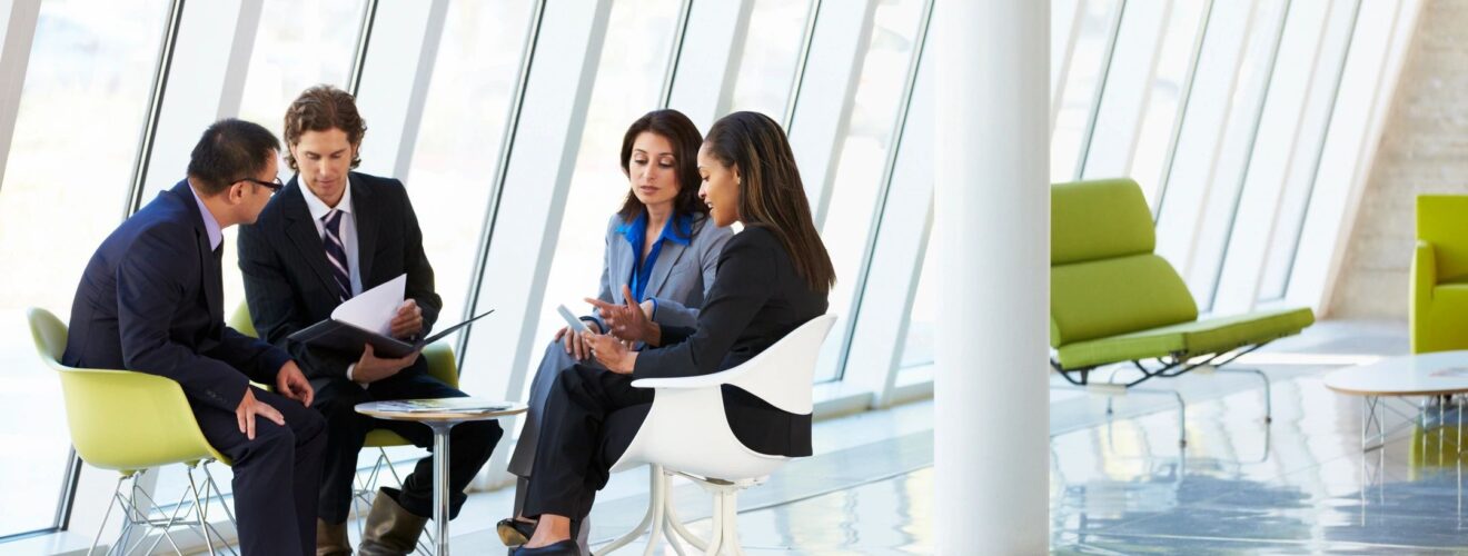 Four people at business meeting.